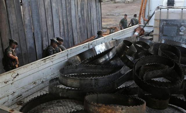 Soldiers from the Brazilian Army stand near a truck loaded with saw blades which they confiscated in Nova Esperanca do Piria