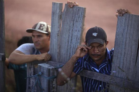 Sawmill workers watch Brazil's environmental police occupy their workplace in Nova Esperanca do Piriau
